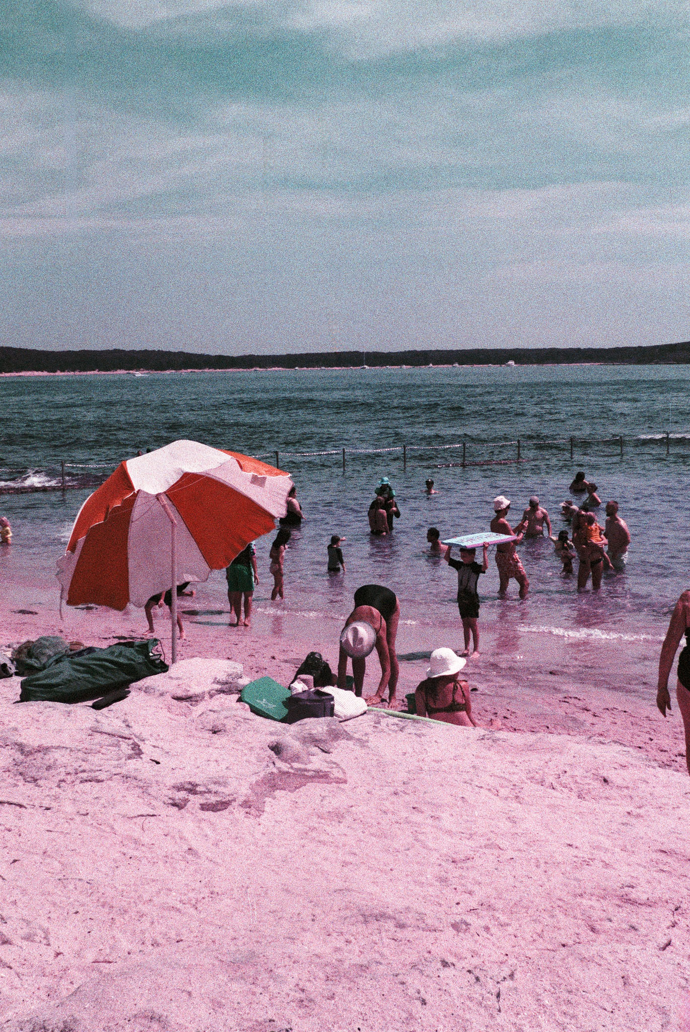 Art deco building and palms on the Cronulla shoreline in purple-shifted tones — 35mm Lomochrome Purple